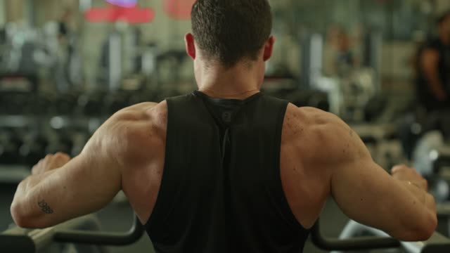 Man exercising on gym equipment.