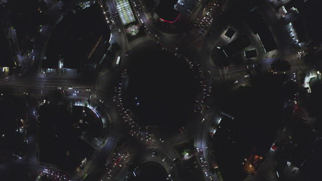 Traffic at a roundabout at night.