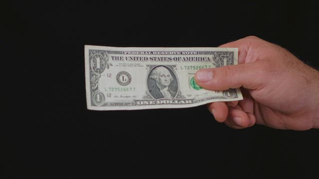 Hands of people during a money transaction.