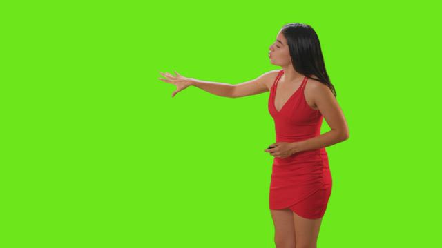 Weather presenter giving newsroom presentation on a green screen.