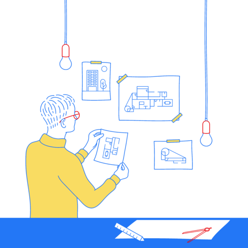 Person arranging a series of designs on an office wall